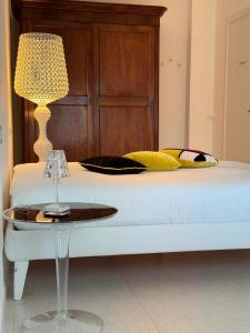 uma cama com uma mesa e um candeeiro em Casa Pellegrino em Polignano a Mare
