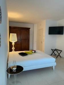 a bedroom with a bed with a table and a lamp at Casa Pellegrino in Polignano a Mare