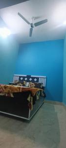 a bed in a room with a ceiling fan at Kishori ram guest house 5 minute walking distance from railway station in Ayodhya
