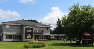 a building with a sign in front of it at The Fort Nashwaak Motel in Fredericton