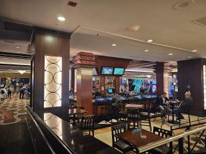 a bar with people sitting at tables in a restaurant at Perfect Spot Unit by Horseshoe Casino Strip Las Vegas in Las Vegas