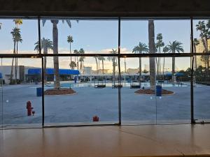 a view of a parking lot with palm trees through a window at Perfect Spot Unit by Horseshoe Casino Strip Las Vegas in Las Vegas