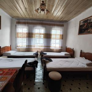 a room with four beds and a window at Te MuzzeU Hostel in Berat