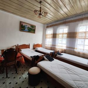 a room with four beds and a ceiling at Te MuzzeU Hostel in Berat