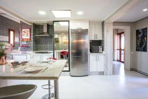 a kitchen with a stainless steel refrigerator in a room at Palm Splendor - Marrakech in Marrakesh