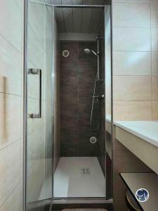 a shower with a glass door in a bathroom at St-Germain - Les Terrasses de l'Ardèche - Piscine in Salavas