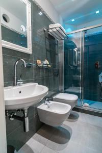 a bathroom with a sink and a toilet and a shower at Teresa Rooms & Suites in La Spezia