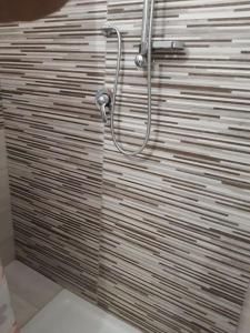 a glass shower door in a bathroom at Affitti brevi Donna Rosa in Racalmuto