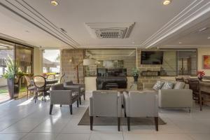 a living room with a couch and a dining room at Flat Pietra in Florianópolis