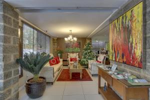 a living room filled with furniture and a christmas tree at Flat Pietra in Florianópolis