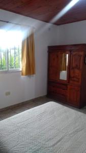 Zimmer mit einem Bett, einer Kommode und einem Fenster in der Unterkunft Departamento tranquilo y luminoso in La Plata