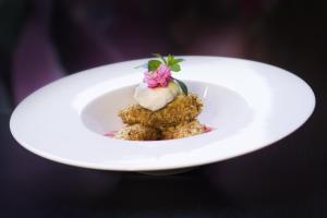 a white plate with a dessert on top of it at Hotel U Kříže in Prague