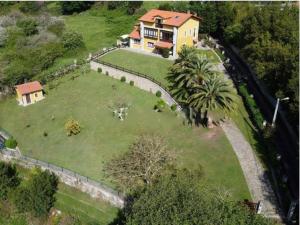 an aerial view of a house with a large yard at El Corral Del Acebo in Nueva de Llanes