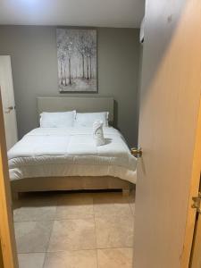 a bedroom with a bed and a painting on the wall at Abel Boutique House in Cartagena de Indias +105 photos