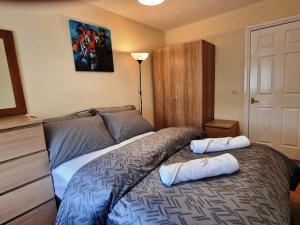 a bedroom with a bed with two pillows on it at 2 Bedroom Flat close to centre in Bristol