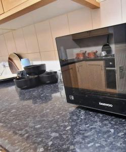 a television sitting on a counter in a kitchen at 2 Bedroom Flat close to centre in Bristol