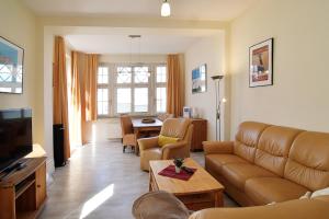 ein Wohnzimmer mit einer Couch und einem Tisch in der Unterkunft Hamburg App. 01 in Ahlbeck