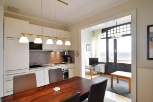 a kitchen and dining room with a wooden table at Strandklause-App-04 in Seebad Bansin in Heringsdorf