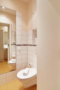 a bathroom with a toilet and a sink and a mirror at Strandklause-App-04 in Seebad Bansin in Heringsdorf +17 photos