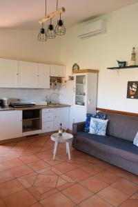 a kitchen and living room with a couch and a table at Casa Adriana - Costa Paradiso in Costa Paradiso