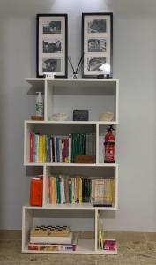 a white book shelf filled with books at B&B Residence Armonia Sulmona in Sulmona