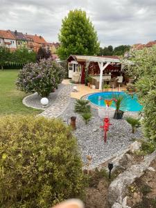 a backyard with a swimming pool and a house at Ferienhaus Lübke Souterrain in Mühlhausen