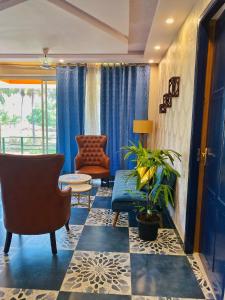 a living room with a couch and a chair at Bluebell Meadows 2BHK in Varca
