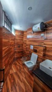 a bathroom with a toilet and a sink at HOTEL INDIA HOUSE in Dharamshala