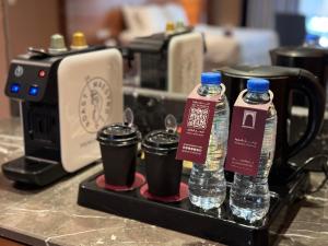 two bottles of water on a tray next to a toaster at Al Safwah Hotel Third Tower in Makkah