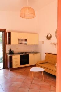 a kitchen with a couch and a table in a room at Casa Adriana - Costa Paradiso in Costa Paradiso +54 photos
