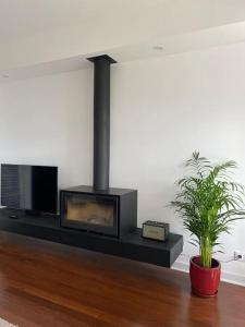 a living room with a fireplace and a tv at Oceanview 4 U - Close to Lisbon! in Oeiras