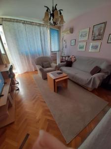 a living room with a couch and a coffee table at Apartman Oskar in Bor