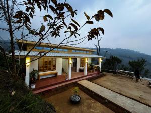 a house with a view of a mountain at Orange Bari Farmstay in Darjeeling