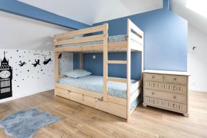 a bunk bed in a room with a clock at Disney Cosy Cottage, 5 minutes Disneyland! in Magny-le-Hongre