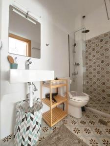 a bathroom with a sink and a toilet at Crysalis Studios in Kalamaki