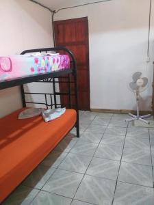 a room with two bunk beds and a fan at Downtown Montezuma Hostel in Montezuma