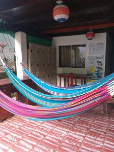 a colorful hammock sitting in front of a building at Downtown Montezuma Hostel in Montezuma