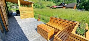 a wooden bench sitting on a wooden deck at Pod Beskydem, Velké Karlovice in Velké Karlovice