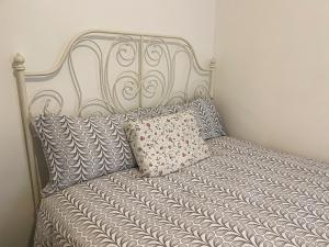 a metal bed with a pillow on top of it at Centrally Located Comfortable Room in London in London