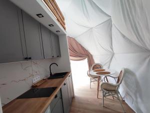 a kitchen with two chairs and a table in a tent at Forrest Glamp in Mieroszów