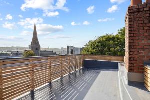 a balcony with a view of a church at Brand New 5 Bedroom House in Plymouth