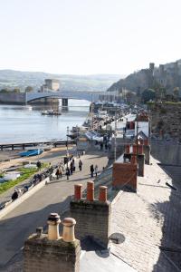 a view of a city with people walking on the street at Harbour Cottage, Conwy in Conwy