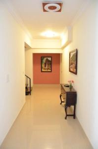 a hallway with a desk and a red wall at Trinity Suites in Bangalore