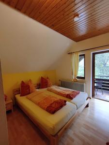 a bedroom with a bed and a large window at Berggasthaus Präger Böden in Todtnau