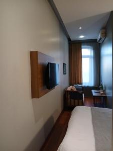 a hotel room with a bed and a tv on the wall at Mayata Gallery in Istanbul