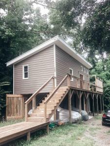 a house with a large deck and a staircase at Modern Treehouse, close to downtown and beach in Wilmington