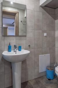 ein Badezimmer mit einem Waschbecken, einem Spiegel und einem WC in der Unterkunft Sergios Apartments 6 in Alexandroupoli