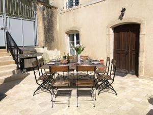 a table and chairs on a patio with a piano at Abbaye de l'Etanche - Un cadre naturel exceptionnel - Patrimoine - in Rollainville