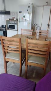 a wooden table and chairs in a kitchen at Alquiler Temporario Río Grande in Río Grande