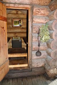 an entrance to a wooden cabin with a table and a window at Russet & Rowanberry - Russet Holiday House in Paide